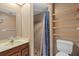 Cozy bathroom featuring a shower with patterned curtain, wooden shelves, and classic sink at 6207 Courtside Dr # 23, Bradenton, FL 34210
