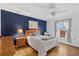 Inviting bedroom with a cozy bed, wood floors, ceiling fan, and natural light from the window at 6207 Courtside Dr # 23, Bradenton, FL 34210