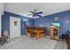 Eat-in kitchen features a table, built-in bench, white tile floor, and a blue accent wall at 6207 Courtside Dr # 23, Bradenton, FL 34210