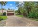 Exterior of a home featuring a two-car garage, concrete driveway and lush front yard at 6207 Courtside Dr # 23, Bradenton, FL 34210