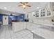 Kitchen with white cabinets, island, granite countertops, and stainless steel appliances at 6207 Courtside Dr # 23, Bradenton, FL 34210