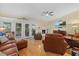 Cozy living room with fireplace, ceiling fan, and french doors leading to outside at 6207 Courtside Dr # 23, Bradenton, FL 34210