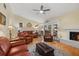 View of living room with fireplace, TV, and leather furniture at 6207 Courtside Dr # 23, Bradenton, FL 34210