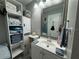 Functional bathroom with ample shelving, a large mirror, and a neutral color palette at 7150 N Tamiami Trl # S-623, Sarasota, FL 34243