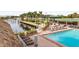 Picturesque community pool area with marina views and plenty of lounge seating surrounded by palm trees at 7150 N Tamiami Trl # S-623, Sarasota, FL 34243