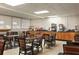 Breakfast area showcasing multiple tables with chairs and food service stations at 7150 N Tamiami Trl # S-623, Sarasota, FL 34243