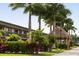Exterior view highlighting the hotel building, with lush tropical landscaping and a tiki hut at 7150 N Tamiami Trl # S-623, Sarasota, FL 34243