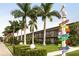 Charming beachfront hotel with lush landscaping and a whimsical pelican signpost at 7150 N Tamiami Trl # S-623, Sarasota, FL 34243
