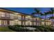 Well-maintained exterior of the building with palm trees and manicured landscaping at 7150 N Tamiami Trl # S-623, Sarasota, FL 34243
