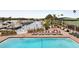 Stunning community pool overlooks a serene marina, complete with lounge chairs and lush landscaping at 7150 N Tamiami Trl # S-623, Sarasota, FL 34243