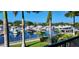 Picturesque waterfront view of the marina, framed by lush greenery and palm trees at 7150 N Tamiami Trl # S-623, Sarasota, FL 34243