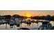 Scenic waterfront view featuring boat docks and a beautiful sunset over the water at 7150 N Tamiami Trl # S-623, Sarasota, FL 34243