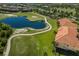 This is an aerial view of a beautiful golf course community, with a lake and well-maintained landscaping at 7179 Boca Grove Pl # 202, Lakewood Ranch, FL 34202
