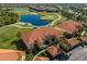 This is an aerial view of the community featuring lakes, a golf course, and well-manicured grounds at 7179 Boca Grove Pl # 202, Lakewood Ranch, FL 34202