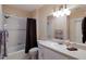 This bathroom offers neutral colors, shower-tub, a large mirror, and ample countertop space at 7179 Boca Grove Pl # 202, Lakewood Ranch, FL 34202