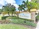 Boca Grove community sign with lush landscaping, stone accents and palm trees against a bright blue sky at 7179 Boca Grove Pl # 202, Lakewood Ranch, FL 34202