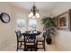 Cozy dining area with elegant lighting fixture, large windows, and a view of the outdoors at 7179 Boca Grove Pl # 202, Lakewood Ranch, FL 34202