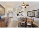 Open-concept dining area with a round table, chairs, and adjacent kitchen view, creating a great entertaining space at 7179 Boca Grove Pl # 202, Lakewood Ranch, FL 34202