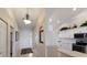 Inviting entryway and modern kitchen showcasing an open and airy living space at 7179 Boca Grove Pl # 202, Lakewood Ranch, FL 34202