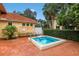 Private hot tub on brick patio with pool rules sign and lush tropical landscaping around the community at 7179 Boca Grove Pl # 202, Lakewood Ranch, FL 34202
