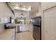 Kitchen featuring white cabinets, stainless steel appliances, and views into the living room at 7179 Boca Grove Pl # 202, Lakewood Ranch, FL 34202