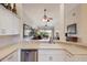 Bright kitchen with stainless steel appliances and breakfast bar open to the living area at 7179 Boca Grove Pl # 202, Lakewood Ranch, FL 34202