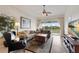 Comfortable living room featuring plush seating, a decorative rug, and sliding glass doors for abundant natural light at 7179 Boca Grove Pl # 202, Lakewood Ranch, FL 34202