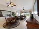 Inviting living room with cozy seating, elegant ceiling fan, and sliding glass doors to a scenic outdoor space at 7179 Boca Grove Pl # 202, Lakewood Ranch, FL 34202
