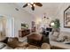 Spacious living room with high ceilings, comfortable furniture, and views into the dining area and kitchen at 7179 Boca Grove Pl # 202, Lakewood Ranch, FL 34202