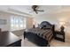 Serene main bedroom with tray ceiling, cozy bedding, window shutters and elegant nightstands at 7179 Boca Grove Pl # 202, Lakewood Ranch, FL 34202