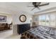 This is a light-filled main bedroom featuring shuttered windows, a ceiling fan, and access to the ensuite and living room at 7179 Boca Grove Pl # 202, Lakewood Ranch, FL 34202