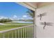 Balcony overlooking scenic landscape with a lake, golf course and clear blue skies at 7179 Boca Grove Pl # 202, Lakewood Ranch, FL 34202