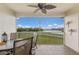 Screened patio with seating area and a scenic view of the golf course and lake at 7179 Boca Grove Pl # 202, Lakewood Ranch, FL 34202