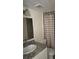Bathroom featuring a shower and tub combo and granite countertops at 7273 Cloister Dr # 121, Sarasota, FL 34231