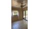 Bright bedroom with tile floors, fan, window, and sliding glass door to the patio at 7273 Cloister Dr # 121, Sarasota, FL 34231