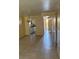 Living room with tile floors leading to kitchen and front door at 7273 Cloister Dr # 121, Sarasota, FL 34231