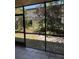Enclosed patio space with screened in area and landscaping at 7273 Cloister Dr # 121, Sarasota, FL 34231