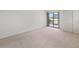 A large bedroom featuring carpet and a sliding glass door to a patio at 7500 40Th W Ave # 108, Bradenton, FL 34209