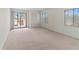 A spacious bedroom features carpeted floors, windows, and sliding glass door to the outside at 7500 40Th W Ave # 108, Bradenton, FL 34209
