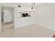 Open-concept dining area with tiled floors and a view into the kitchen at 7500 40Th W Ave # 108, Bradenton, FL 34209