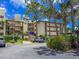 Building exterior featuring parking, mature trees, and meticulously landscaped grounds at 7500 40Th W Ave # 108, Bradenton, FL 34209