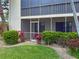 Building displays ground floor screened lanai, well-maintained landscaping, and a peaceful outdoor living space at 7500 40Th W Ave # 108, Bradenton, FL 34209