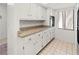 Bright kitchen featuring white cabinets, stone countertops, and modern appliances at 7500 40Th W Ave # 108, Bradenton, FL 34209