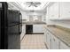 Updated kitchen with white cabinets, stone countertops, and modern appliances at 7500 40Th W Ave # 108, Bradenton, FL 34209