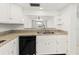 Well-lit kitchen featuring stone countertops and an open view to the dining area at 7500 40Th W Ave # 108, Bradenton, FL 34209