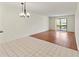 A bright living room features tile and wood flooring and a sliding glass door to the outdoors at 7500 40Th W Ave # 108, Bradenton, FL 34209