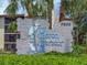 Community sign with palm trees, landscaping, and building exterior at 7500 40Th W Ave # 108, Bradenton, FL 34209