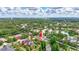 Aerial view showcases the home, lush greenery, and community pond, creating a serene backdrop at 7705 55Th E St, Ellenton, FL 34222