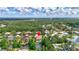 Aerial view showcases the home, lush greenery, and community pond, creating a serene backdrop at 7705 55Th E St, Ellenton, FL 34222