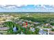 Aerial view of a beautiful home backing to a pond in a tranquil neighborhood with lush greenery at 7705 55Th E St, Ellenton, FL 34222